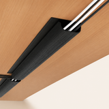Desklear Under Desk Cable Tray mounted beneath a wood desk, holding cables out of sight
